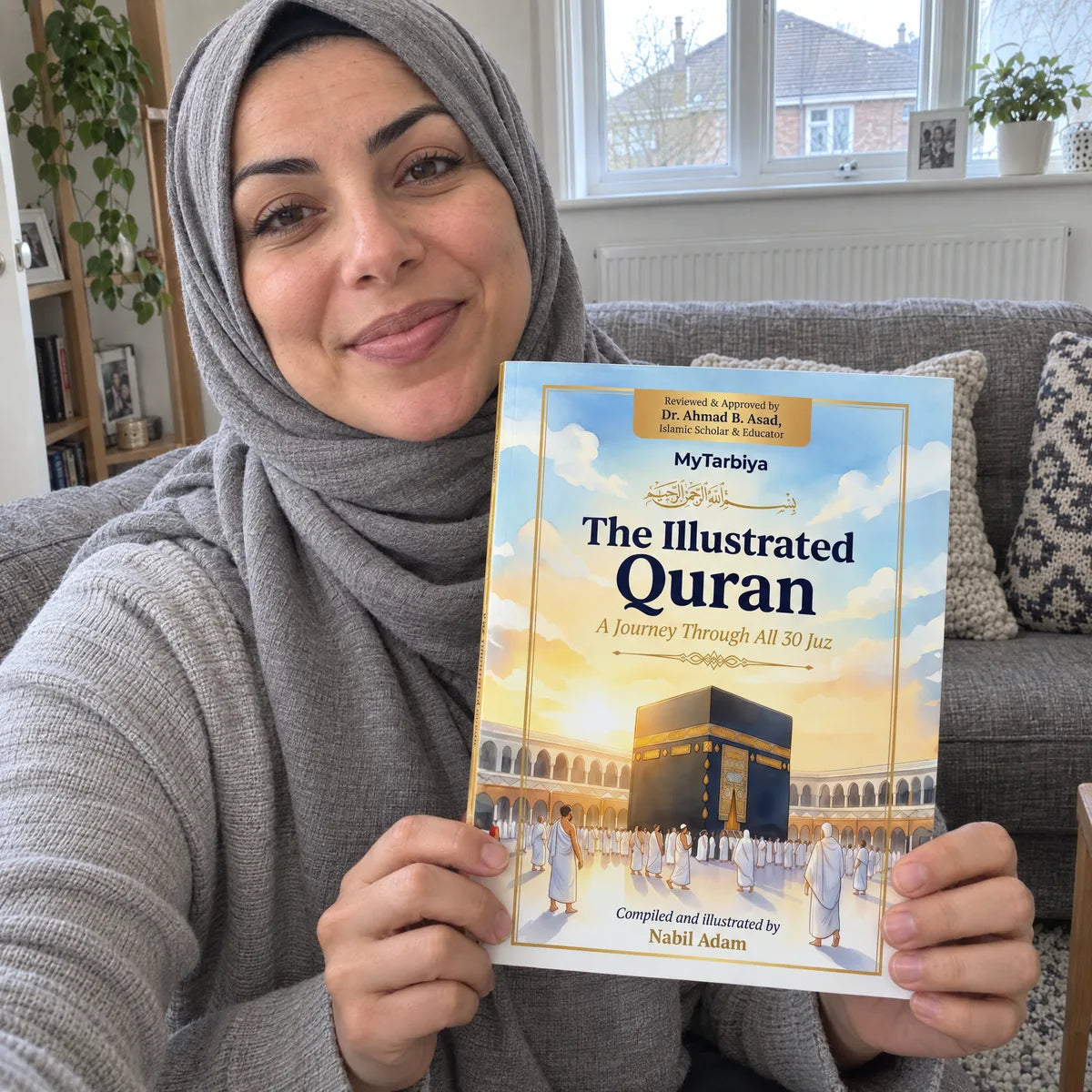 A mother holding The Illustrated Quran cover-out in a phone selfie