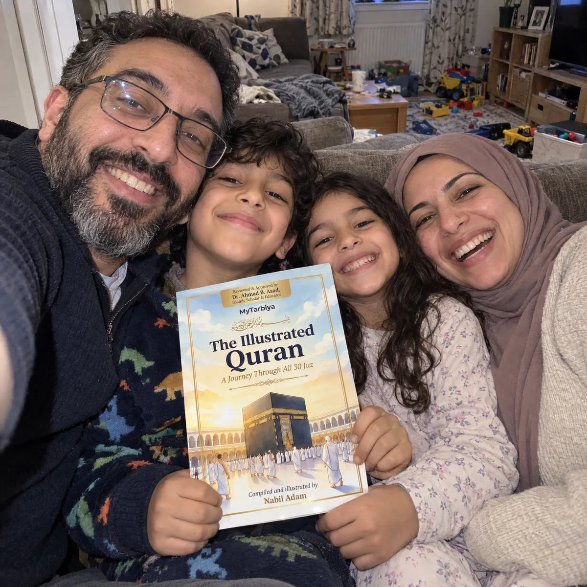 A family selfie on the sofa with The Illustrated Quran